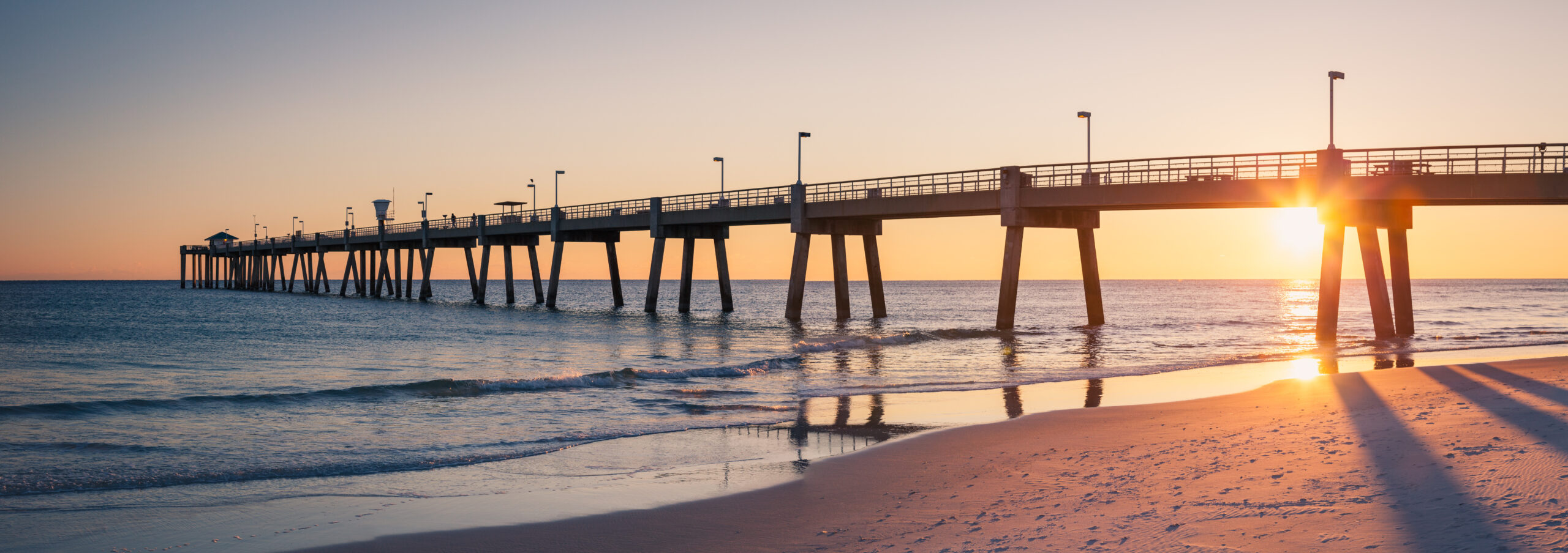 Panorama of Okaloosa fishing pier in Fort Walton Beach, Florida at sunset.